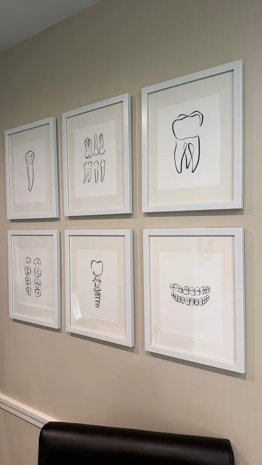 Six framed single-line tooth drawings on the hallway wall
