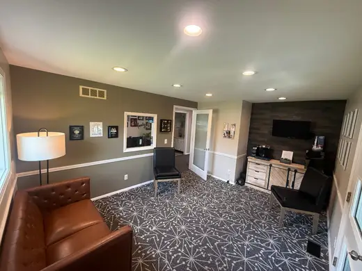 The waiting room at Noblesville Dental Associates, with leather seating and a coffee station for guests