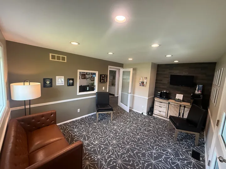 The waiting room at Noblesville Dental Associates, with leather seating and a coffee station for guests