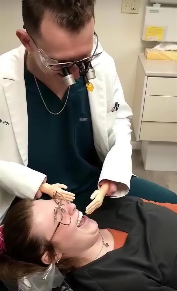 Dr. Berry sharing a laugh with a patient in the exam chair, from a video on our Facebook page
