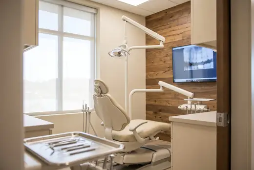 Ceramic crowns resting on a plaster arch model at a warm dental laboratory bench